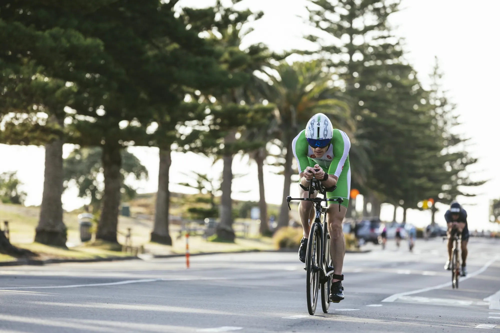 Mark Bowstead riding the Tauranga Half bike course along the flat, pine-lined coast road at Mount Maunganui