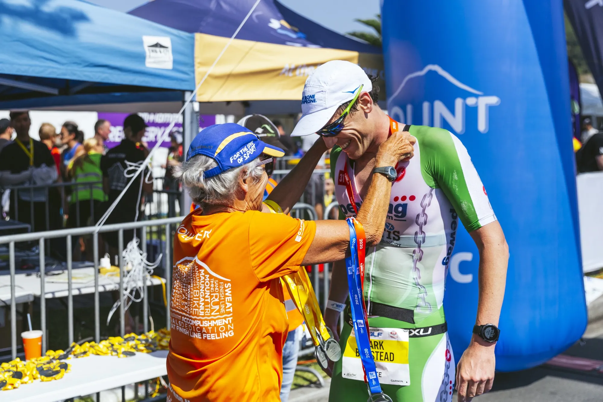 Mark Bowstead receiving his finisher’s medal at the Mount Maunganui Half